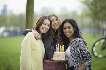 Porträt glückliche junge Frauen Freunde feiern Geburtstag im Park - CAIF31938
