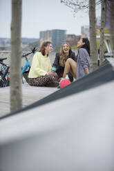 Happy young women friends in city park - CAIF31967