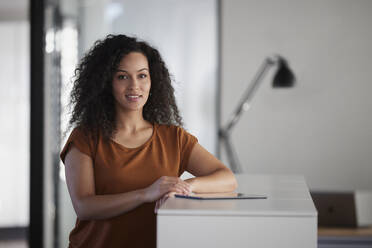 Businesswoman with tablet PC on desk in office - RBF08504