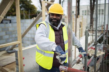 Portrait confident male construction worker at construction site - CAIF32119