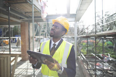 Engineer with digital tablet at construction site - CAIF32127