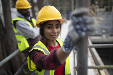 Portrait confident female construction worker at construction site - CAIF32139