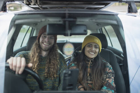 Portrait happy couple on road trip in car - CAIF32190