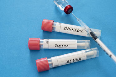 Injection and swab tubes with medical samples against blue background - DRF01784