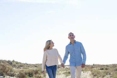 Couple walking together at dunes - EIF02834