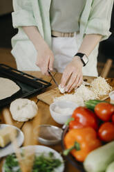 Woman cutting onion on board at home - SEAF00269