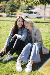 Cheerful friends spending sunny day on lawn - OMIF00294