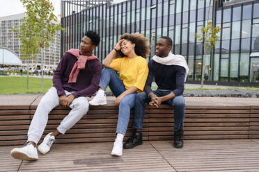 Contemplative young friends sitting on bench - VYF00798