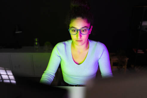 Freelance worker with eyeglasses working at home office - GIOF14641
