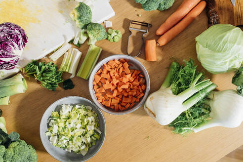 Chopped and sliced fresh vegetables on table at home - MEUF05094