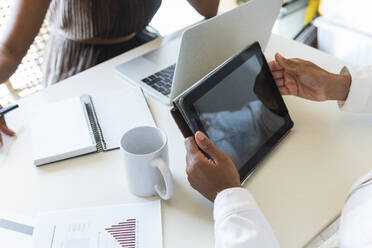 Frau benutzt Tablet-PC mit Freund bei der Arbeit zu Hause - PNAF02662