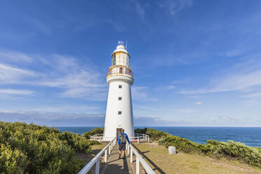Australia, Victoria, Cape Otway, Male tourist walking along footpath leading to Cape Otway Lighthouse in Great Otway National Park - FOF12484