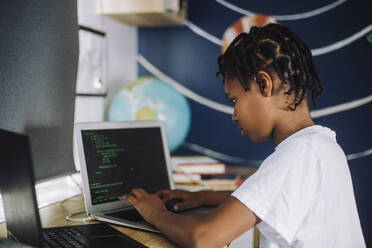 Female student learning coding on laptop at table - MASF28211