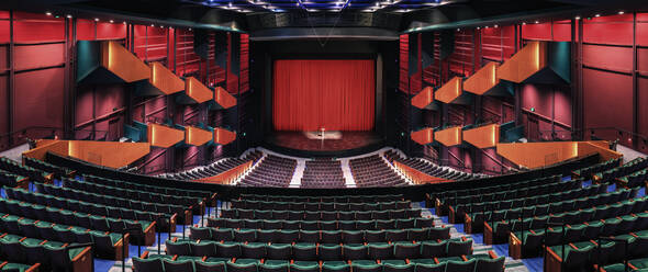 Empty theatre auditorium, stage with a red curtain, boxes and modern design. - MINF16491