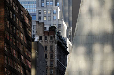 Buildings in New York City, view from below, historic and modern architecture, shadows and sunlight - MINF16499
