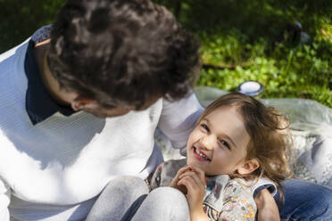 Cute daughter lying on father's lap - DIGF17371