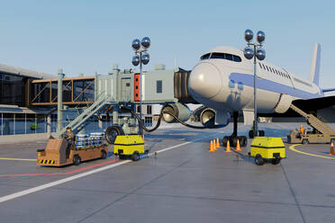 Three dimensional render of passenger boarding bridge connected to airplane waiting at airport - SPCF01603