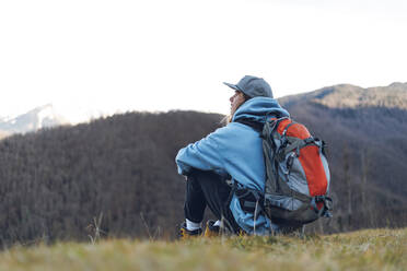 Backpacker looking at view from mountain - OMIF00345