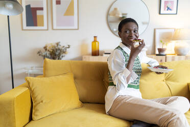 Happy woman enjoying breakfast being at home - JCZF00884