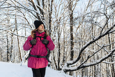 Tourist exploring in snowy forest - OMIF00371