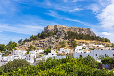 Hill with Acropolis near town of Lindos on sunny day, Rhodes, Greece - MHF00548