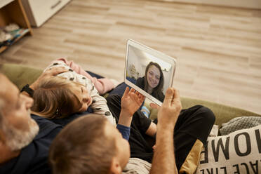 Grandfather with grandchildren doing video call on tablet PC at home - ZEDF04390