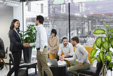 Business colleagues handshaking in office waiting room - EIF02949