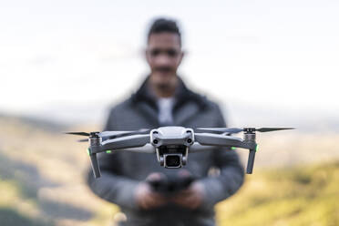 Man operating drone with controller - DLTSF02582