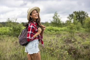 Cheerful woman with hat and backpack at Cannock Chase - WPEF05662