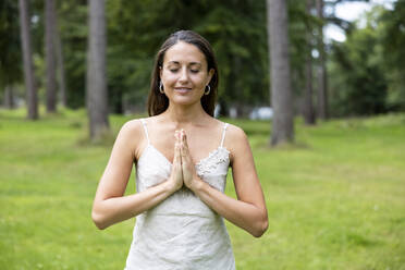 Smiling woman practicing yoga at Cannock Chase - WPEF05684
