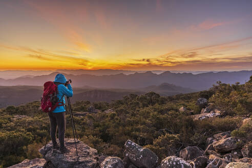 Australien, Victoria, Weibliche Touristin, die Bilder vom Mount William bei Sonnenuntergang macht - FOF12626