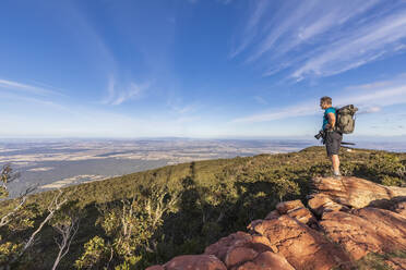 Australia, Victoria, Male tourist admiring surrounding landscape from Mount William in Grampians National Park - FOF12630