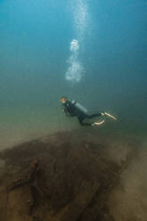 Scuba diver diving undersea at Del Coco beach - RSGF00821