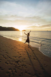 Woman enjoying sunset dance at Del Coco beach, Guanacaste Province, Costa Rica - RSGF00829
