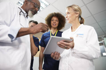 Healthcare professionals with tablet PC conducting meeting at hospital - PMF02143