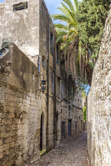Greece, Rhodes, Rhodes, Old town alley stretching between stone buildings - MHF00556