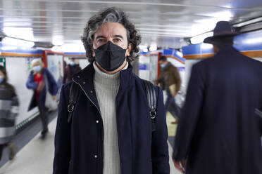 Mann mit Gesichtsschutzmaske an einer U-Bahn-Station - IFRF01383