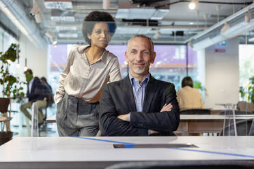 Business colleagues seen through glass in coworking space - EIF03086