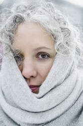 Woman with gray curly hair wrapped in scarf - SEAF00384