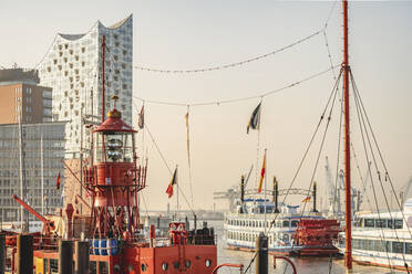 Germany, Hamburg, Harbor in front of Elbphilharmonie with lightship in foreground - KEBF02164