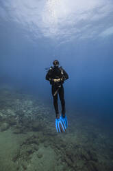 Young man wearing diving equipment undersea - RSGF00843