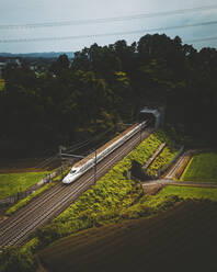 Aerial view of a Shinkansen train on a railroad in Japan. - AAEF13785