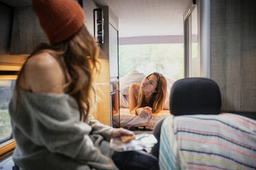 Friends spending leisure time in camper van - MRRF01840