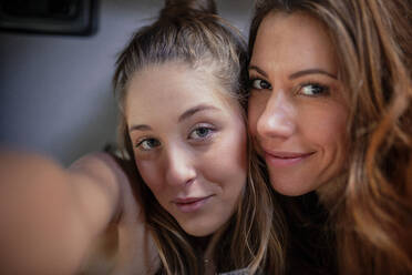 Smiling female friends taking selfie - MRRF01846