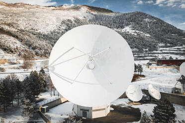 Aerial view of a large satellite dish at Signalhorn station in winter, Leuk, Switzerland. - AAEF13885