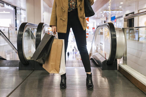 Woman with shopping bags in mall - JRVF02644