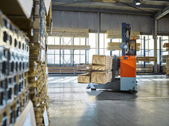 Warehouse worker operating forklift in industrial building - CVF01809