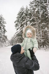 Father picking up cute daughter in winter - EYAF01883