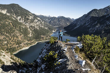 Woman trail running at Tauern above Lake Plansee, Ammergau Alps, Reutte, Tyrol, Austria - WFF00621