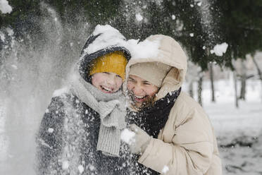 Cheerful son and mother enjoying in snow - SEAF00418